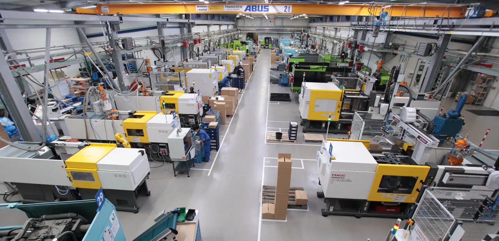 Injection moulding hall seen from above, rows of Fanuc and Engel machines